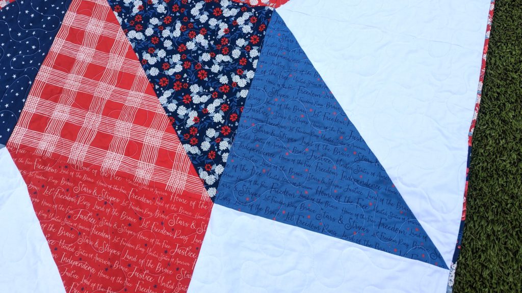 Close up of red, white, and blue giant star quilt made with the Land of the Brave fabric collection