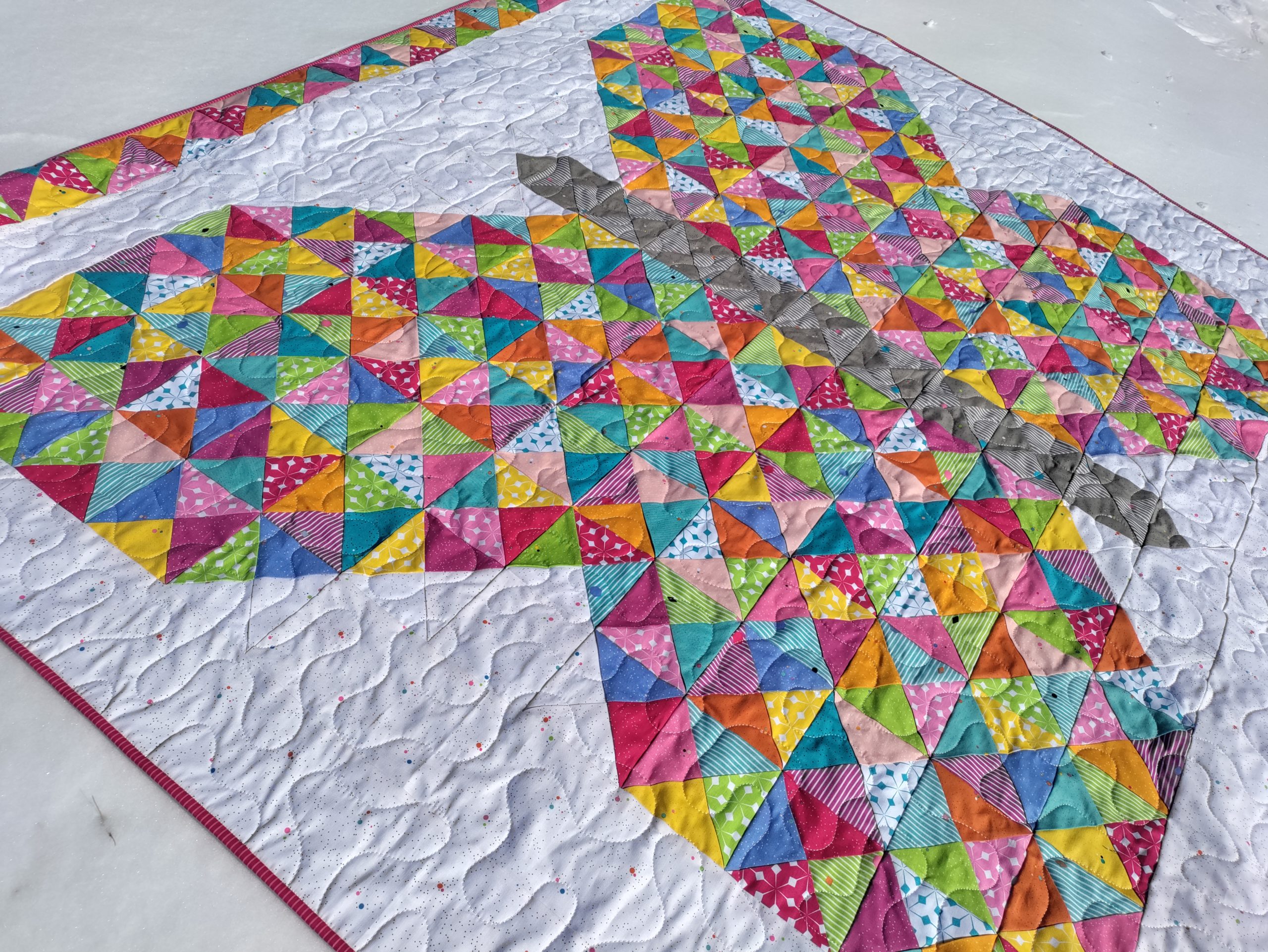 The Flutterfly butterfly quilt made with brightly colored fabric triangles from the Colour Wall collection by Riley Blake Designs