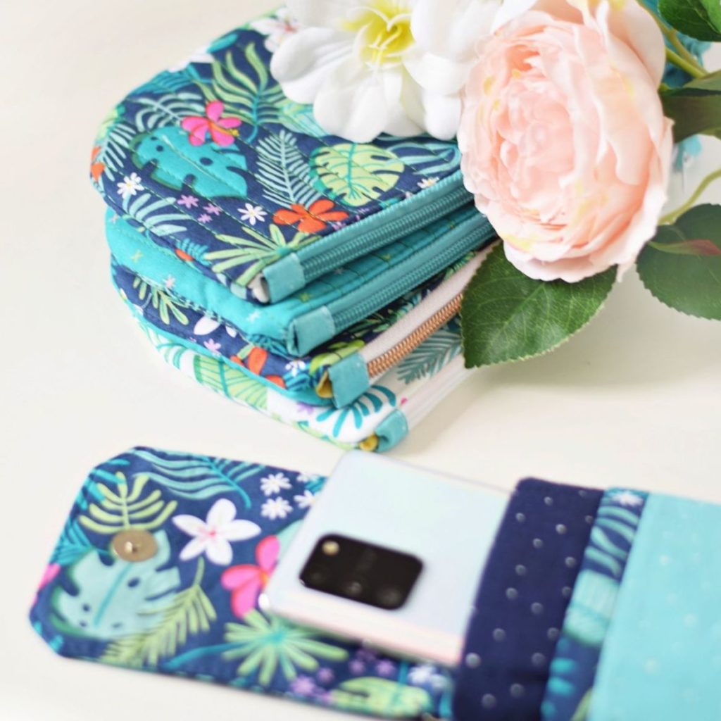 a phone pouch and a pile of quilted zipper pouches