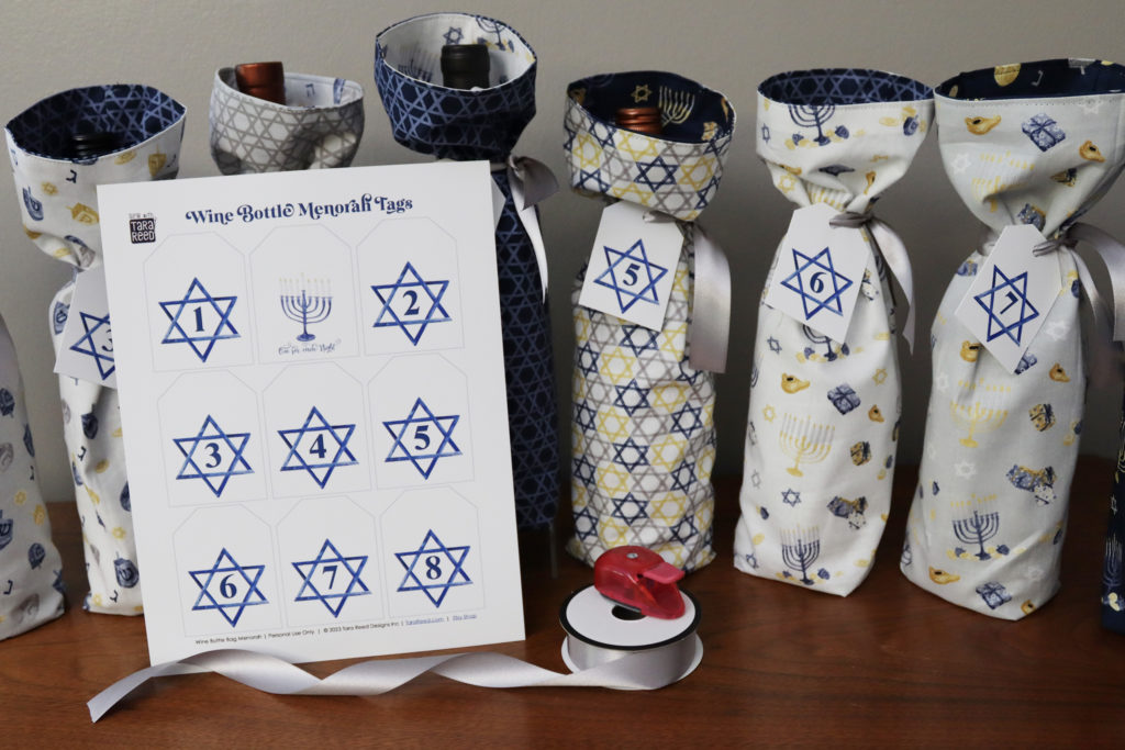 get the free printable tags by Tara Reed to make a wine bottle menorah for Hanukkah