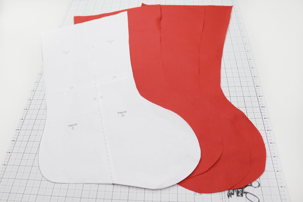 Christmas stocking template and red fabric cut to size
